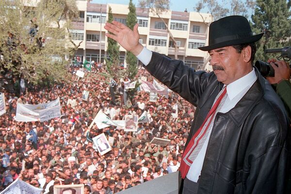 A photo released by Iraqi Press Agency 02 April shows President Saddam Hussein waving to supporters during his visit to the town of Kirkuk north of Baghdad. A photo released by Iraqi Press Agency 02 April shows President Saddam Hussein waving to supporters during his visit to the town of Kirkuk north of Baghdad. - Sputnik International