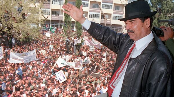 A photo released by Iraqi Press Agency 02 April shows President Saddam Hussein waving to supporters during his visit to the town of Kirkuk north of Baghdad. - Sputnik International