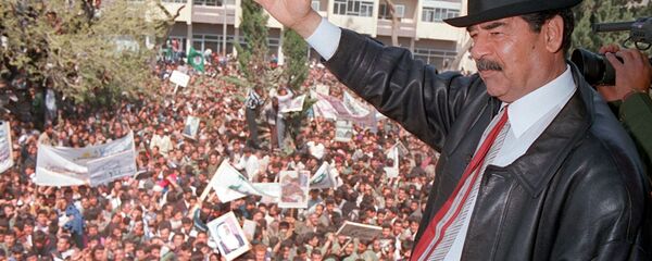 A photo released by Iraqi Press Agency 02 April shows President Saddam Hussein waving to supporters during his visit to the town of Kirkuk north of Baghdad. - Sputnik International