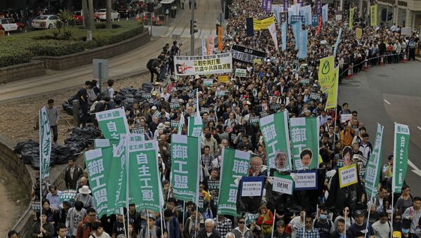 Thousands of people march on the first day of 2017 at a downtown street in Hong Kong Sunday, Jan. 1, 2017, to protest against Beijing's interpretation of Basic Law and Hong Kong government's bid to ban pro-democracy lawmakers from taking office. They also demand true universal suffrage, which is not happening in the coming chief executive election in March. - Sputnik International
