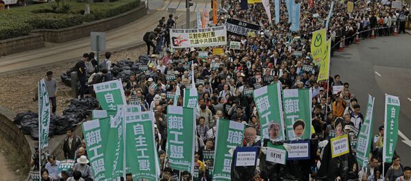 Thousands of people march on the first day of 2017 at a downtown street in Hong Kong Sunday, Jan. 1, 2017, to protest against Beijing's interpretation of Basic Law and Hong Kong government's bid to ban pro-democracy lawmakers from taking office. They also demand true universal suffrage, which is not happening in the coming chief executive election in March. Thousands of people march on the first day of 2017 at a downtown street in Hong Kong Sunday, Jan. 1, 2017, to protest against Beijing's interpretation of Basic Law and Hong Kong government's bid to ban pro-democracy lawmakers from taking office. They also demand true universal suffrage, which is not happening in the coming chief executive election in March. - Sputnik International