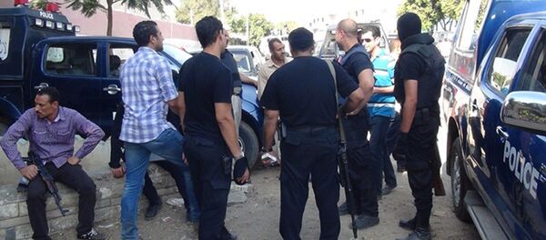 Egyptian policemen take position in the village of Delga, in the central Minya province, on September 16, 2013 after Egyptian troops stormed the town held for over a month by hardline supporters of ousted Islamist president Mohamed Morsi who had launched a campaign against Christian residents Egyptian policemen take position in the village of Delga, in the central Minya province, on September 16, 2013 after Egyptian troops stormed the town held for over a month by hardline supporters of ousted Islamist president Mohamed Morsi who had launched a campaign against Christian residents - Sputnik International