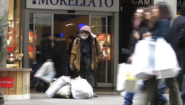 A beggar stands in Vittorio Emanuele shopping street in Milan, Italy, Wednesday, Dec.21, 2011 - Sputnik International