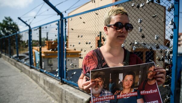 A demostrator holds a placard of Reporters Without Borders Turkey representative Erol Onderoglu, journalist Ahmet Nesin and rights activist and academic Sebnem Korur Fincanci during a demostration in front of the Metris prison on June 24, 2016 in Istanbul - Sputnik International