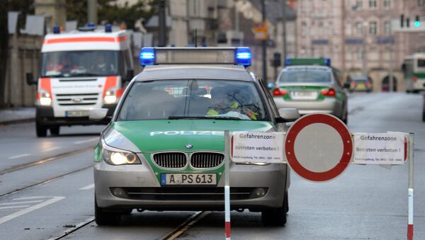 Police cars are seen beside a road block on an empty street in Augsburg, southern Germany - Sputnik International