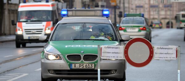 Police cars are seen beside a road block on an empty street in Augsburg, southern Germany Police cars are seen beside a road block on an empty street in Augsburg, southern Germany - Sputnik International