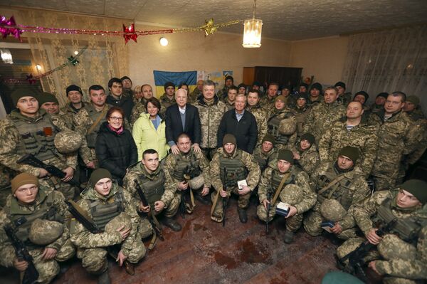 Ukrainian President Petro Poroshenko centre, Chairman of Senate Armed Services Committee, US Senator John McCain, centre left, US Senator Lindsey Graham, centre right, and US Senator Amy Klobuchar pose for photo with the Ukrainian marines, during their working trip to the Donetsk region to congratulate Ukrainian servicemen on the upcoming New Year, in the village Shyrokine, eastern Ukraine, Saturday, Dec. 31, 2016 Ukrainian President Petro Poroshenko centre, Chairman of Senate Armed Services Committee, US Senator John McCain, centre left, US Senator Lindsey Graham, centre right, and US Senator Amy Klobuchar pose for photo with the Ukrainian marines, during their working trip to the Donetsk region to congratulate Ukrainian servicemen on the upcoming New Year, in the village Shyrokine, eastern Ukraine, Saturday, Dec. 31, 2016 - Sputnik International