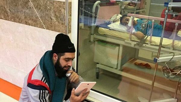 An Iranian teacher visiting his student at hospital. file photo - Sputnik International