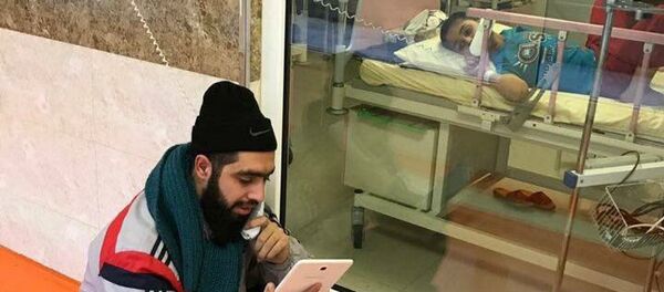 An Iranian teacher visiting his student at hospital. file photo - Sputnik International