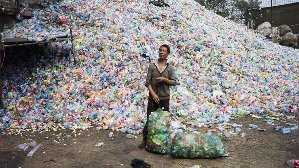 Chinese labourer sorting out plastic bottles for recycling in Dong Xiao Kou village, on the outskirt of Beijing (File) - Sputnik International