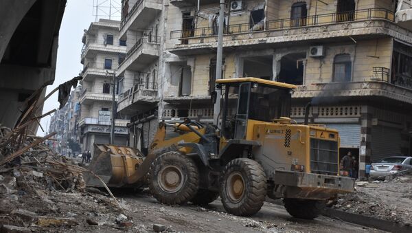 Tractors are seen as the Syrian government starts to clean up areas formerly held by opposition forces in the northern city of Aleppo on December 27, 2016 - Sputnik International