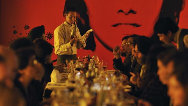 In this Sunday, Jan. 16, 2011 photo, a waiter serves wine to a group learning wine appreciation and fine dining, being conducted by Tulleeho Beverage Innovations at a restaurant in New Delhi, India - Sputnik International
