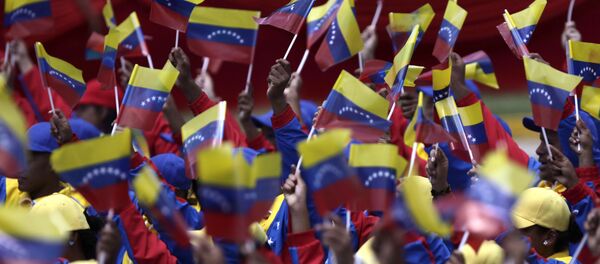 People wave Venezuelan flags during a parade marking 200 years of Venezuela's independence in Caracas, Venezuela, Tuesday July 5, 2011. - Sputnik International
