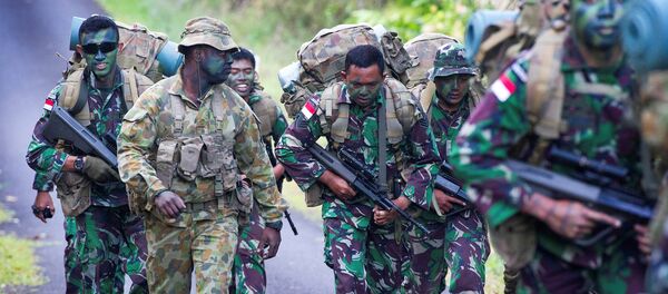 Australian Army soldier Sergeant Francis Jakis (L) is pictured with Indonesian Army soldiers during the Junior Officer Combat Instructor Training course conducted by the Australian Army's Combat Training Centre in Tully, Australia, October 10, 2014 - Sputnik International