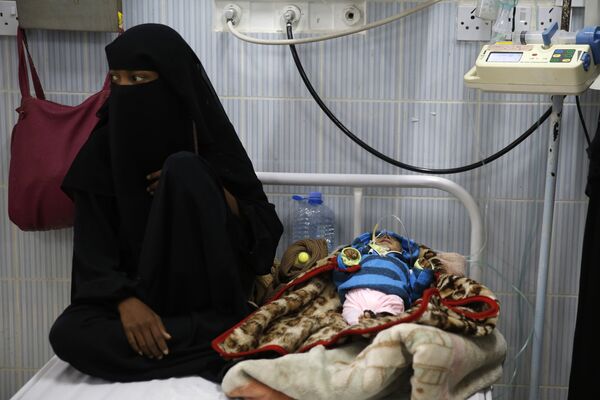 A woman sits next to her malnourished baby at a therapeutic feeding center in a hospital in Sanaa, Yemen. There have been numerous reported cases of dying from starvation in Yemeni hospitals. A woman sits next to her malnourished baby at a therapeutic feeding center in a hospital in Sanaa, Yemen. There have been numerous reported cases of dying from starvation in Yemeni hospitals. - Sputnik International