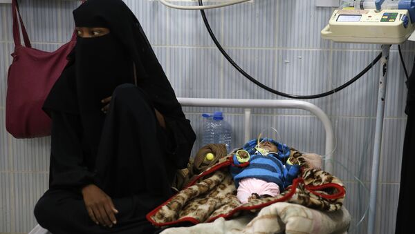 A woman sits next to her malnourished baby at a therapeutic feeding center in a hospital in Sanaa, Yemen. There have been numerous reported cases of dying from starvation in Yemeni hospitals. - Sputnik International