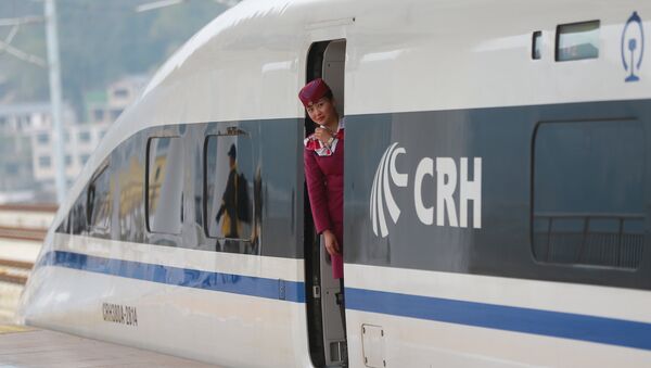 A staff looks out from a high-speed railway train linking Shanghai and Kunming, of Yunnan province, after a partial operation, in Guanling, Guizhou province, China, December 28, 2016. Picture taken December 28, 2016 - Sputnik International