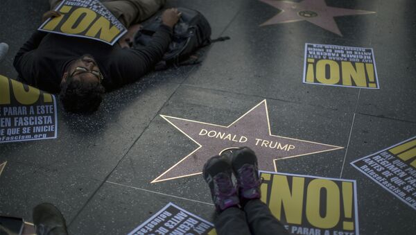 People hold a die-in protest at the Hollywood Walk of Fame star for Donald Trump on Christmas Day in reaction against a Twitter post by US President-elect Trump referring to expansion of the United States nuclear arsenal on December 25 in Los Angeles, California - Sputnik International