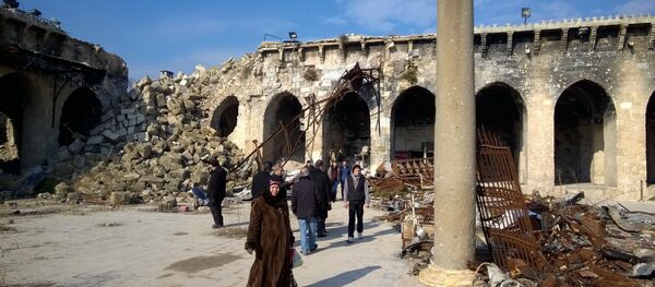 Citizens at a yard of the Umayyad Mosque of Aleppo destroyed following military actions. The Umayyad Mosque was the largest and the oldest mosque of Aleppo Citizens at a yard of the Umayyad Mosque of Aleppo destroyed following military actions. The Umayyad Mosque was the largest and the oldest mosque of Aleppo - Sputnik International