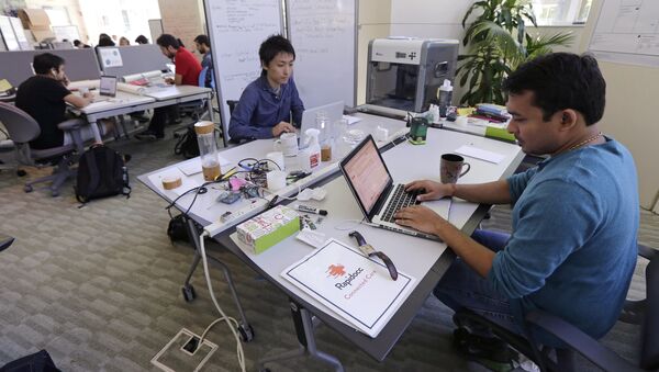 In this Thursday, June 30, 2016 photo, Babson College graduate school alumnus Abhinav Sureka, of Mumbai, India, right, types in his work space at the college in Wellesley, Mass. Some U.S. colleges are starting programs to help their alumni get visas through what critics say is a legal loophole - Sputnik International