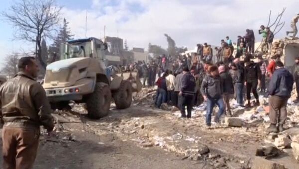 A still image taken from a video obtained by Reuters shows people and a bulldozer moving debris after a fuel truck exploded in the centre of rebel-held Azaz, near Syria's border with Turkey, January 7, 2017. - Sputnik International