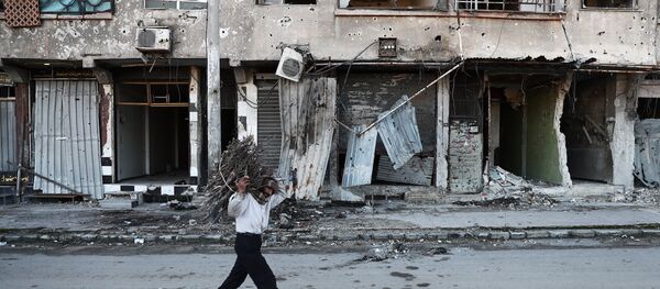 A Syrian man carries wood to be used for heating in the rebel-held town of Douma, on the eastern outskirts of Damascus A Syrian man carries wood to be used for heating in the rebel-held town of Douma, on the eastern outskirts of Damascus - Sputnik International