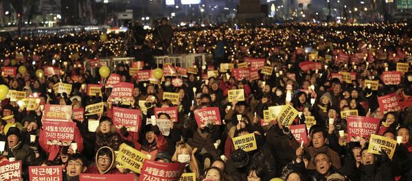 Protesters shout slogans during a candle light vigil calling for impeached President Park Geun-hye to step down in Seoul, South Korea Protesters shout slogans during a candle light vigil calling for impeached President Park Geun-hye to step down in Seoul, South Korea - Sputnik International