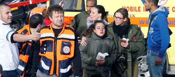 An Israeli soldier escorts another at the scene of a truck ramming incident in Jerusalem An Israeli soldier escorts another at the scene of a truck ramming incident in Jerusalem - Sputnik International