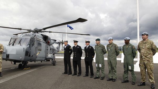 British forces' personnel stand to attention in front of a new AgustaWestland AW159 Wildcat helicopter at the Farnborough International Airshow in Farnborough, England (file) - Sputnik International