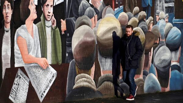 A man walks past a mural on the Falls Road a day after Northern Ireland's Deputy First Minister Martin McGuinness resigned, throwing the devolved joint administration into crisis, in Belfast Northern Ireland, January 10, 2017. - Sputnik International