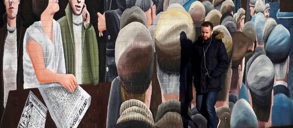 A man walks past a mural on the Falls Road a day after Northern Ireland's Deputy First Minister Martin McGuinness resigned, throwing the devolved joint administration into crisis, in Belfast Northern Ireland, January 10, 2017. A man walks past a mural on the Falls Road a day after Northern Ireland's Deputy First Minister Martin McGuinness resigned, throwing the devolved joint administration into crisis, in Belfast Northern Ireland, January 10, 2017. - Sputnik International