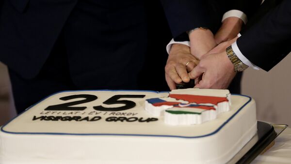 Prime Ministers of Czech Republic Bohuslav Sobotka, Poland Beata Szydlo, Hungary Viktor Orban, and Slovakia Robert Fico, join hands to cut a cake to celebrate 25th anniversary of the establishment of the Visegrad group prior to a Summit of the V4 Prime Ministers with the Prime Minister of Bulgaria and the President of Macedonia in Prague, Czech Republic, Monday, Feb. 15, 2016 - Sputnik International