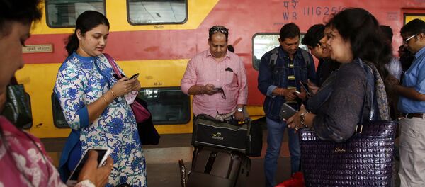 Indian travellers use a free WiFi service to browse the net at Mumbai Central Train Station in Mumbai, India, Friday, Jan. 22, 2016 Indian travellers use a free WiFi service to browse the net at Mumbai Central Train Station in Mumbai, India, Friday, Jan. 22, 2016 - Sputnik International