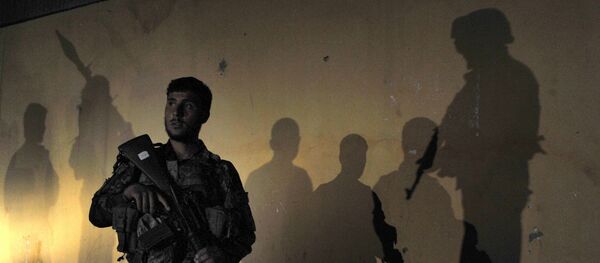 An Afghan security official is surrounded by the shadows of colleagues (File) An Afghan security official is surrounded by the shadows of colleagues (File) - Sputnik International