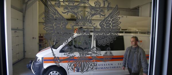 In this Thursday, Sept. 29, 2016 photo, a worker passes by a rescue mission van in a warehouse in a Russian-Serbian Humanitarian Center near an airport in the town of Nis, Serbia - Sputnik International