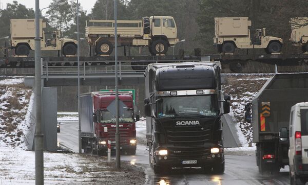 American military vehicles are transported by train cross a bridge in Zagan Poland, on Thursday, Jan. 12, 2017 - Sputnik International