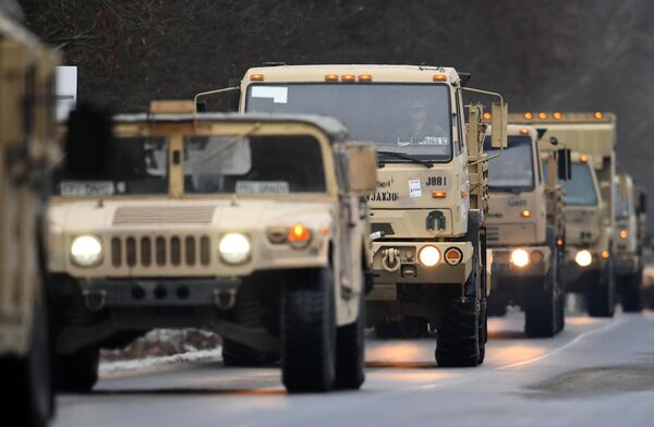 US military vehicles make their way on an army training camp near Brueck, northeastern Germany, on January 11, 2017 - Sputnik International