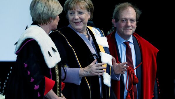 German Chancellor Angela Merkel (C) talks to Rector Anne De Paepe (L) of Belgian UGent university during a ceremony to receive a degree Honoris Causa, or honorary doctorate from the Belgian universities of KU Leuven and UGent in Brussels, Belgium January 12, 2017. - Sputnik International