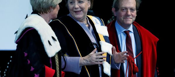 German Chancellor Angela Merkel (C) talks to Rector Anne De Paepe (L) of Belgian UGent university during a ceremony to receive a degree Honoris Causa, or honorary doctorate from the Belgian universities of KU Leuven and UGent in Brussels, Belgium January 12, 2017. - Sputnik International