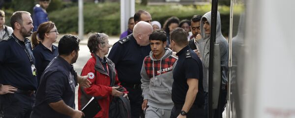 Two unidentified young migrants get off a bus as they arrive at Lunar House, which houses the headquarters of UK Visas and Immigration, in Croydon, south London, Monday, Oct. 17, 2016 Two unidentified young migrants get off a bus as they arrive at Lunar House, which houses the headquarters of UK Visas and Immigration, in Croydon, south London, Monday, Oct. 17, 2016 - Sputnik International