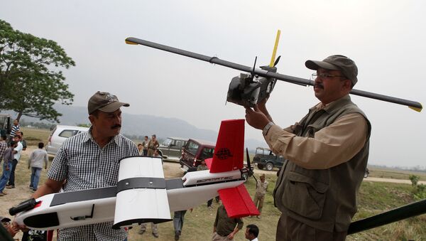 Indian forestry officials hold up unmanned aerial vehicles (UAV) during a demonstration to the media at the Kaziranga National Park, some 250 kilometers east of Guwahati (File) - Sputnik International