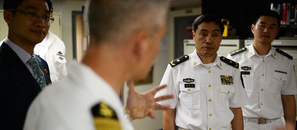 Capt. Kyle P. Higgins, commanding officer of the U.S. 7th Fleet flagship USS Blue Ridge, conducts a ship tour with Vice Adm. Jinlong Shen of the People's Liberation Army Navy. - Sputnik International