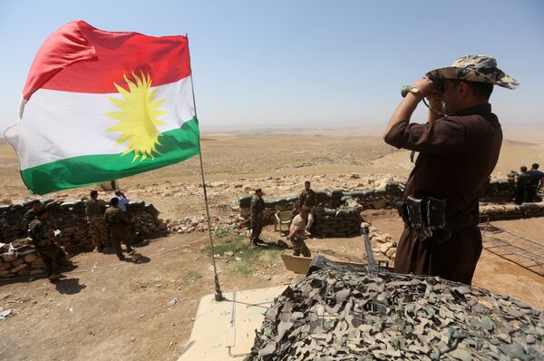A flag of the autonomous Kurdistan region flies as Iraqi Kurdish Peshmerga fighters take position to monitor the area from their front line post in Bashiqa, a town 13 kilometres north-east of Mosul (File) A flag of the autonomous Kurdistan region flies as Iraqi Kurdish Peshmerga fighters take position to monitor the area from their front line post in Bashiqa, a town 13 kilometres north-east of Mosul (File) - Sputnik International