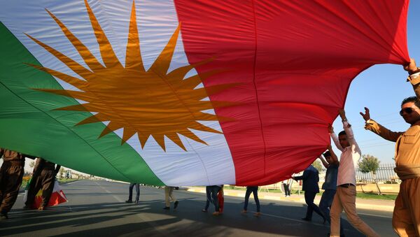 Iraqi Kurdish demonstrators wave a large Kurdish flag (File) - Sputnik International