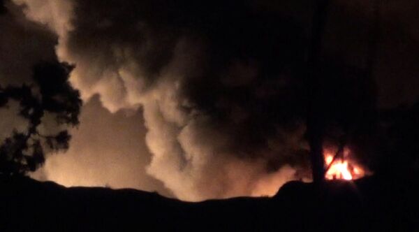 Smoke and flames are seen near Mezzah military airport, near Damascus, Syria, in this still image from video obtained by Reuters January 13, 2017 - Sputnik International