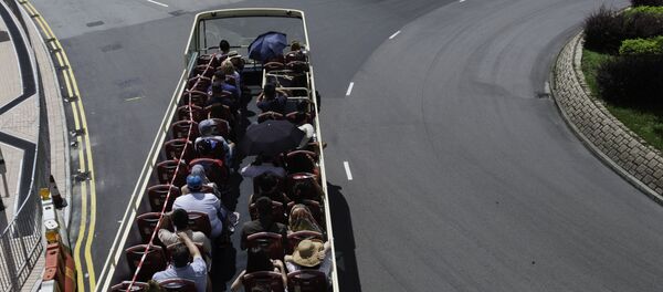 Tourists ride an open-top double decker bus in the Central district of Hong Kong on September 11, 2016 Tourists ride an open-top double decker bus in the Central district of Hong Kong on September 11, 2016 - Sputnik International