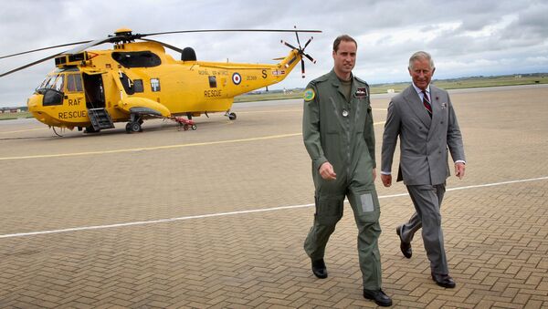 Britain's Prince Charles (R) and his son Prince William walk back to the RAF Rescue base after Prince William showed his father round his RAF Rescue helicopter at RAF Valley on July 9, 2012, in north-west England - Sputnik International