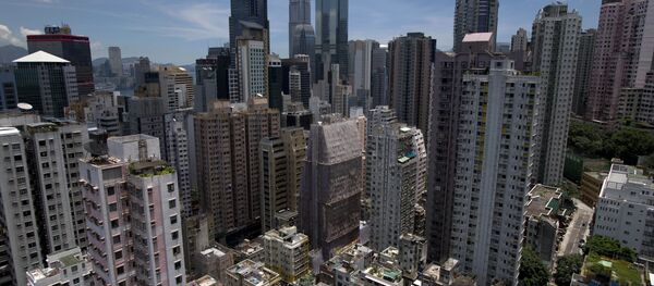 The Sheung Wan neighbourhood (bottom) on Hong Kong island is seen from a residential building with the skyscrapers of the central business district behind. (File) The Sheung Wan neighbourhood (bottom) on Hong Kong island is seen from a residential building with the skyscrapers of the central business district behind. (File) - Sputnik International