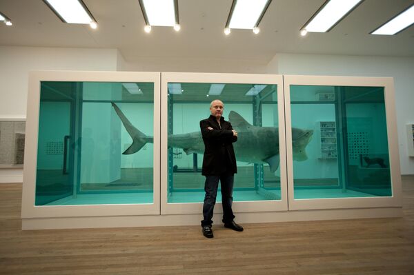 British artist Damien Hirst poses for photographers beside the 1991 piece The Physical Impossibility of Death in the Mind of Someone Living. (File) British artist Damien Hirst poses for photographers beside the 1991 piece The Physical Impossibility of Death in the Mind of Someone Living. (File) - Sputnik International