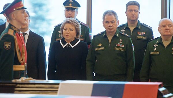 Center, from left: Valentina Matviyenko, chairman of the Russian Federation Council, and Army General Sergei Shoigu, Russian defense minister, during the farewell ceremony for the victims of the Tu-154 crash over the Black Sea, at the Federal Military Memorial Cemetery in the Moscow region. - Sputnik International